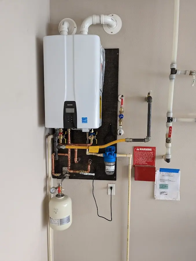 Professional plumber installing copper piping in a Montgomery Village home